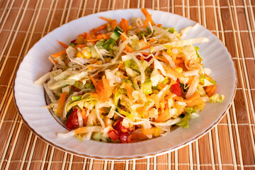 Salad that includes corn kernels, tomatoes, cucumbers, carrots, lettuces is very healthy diet food