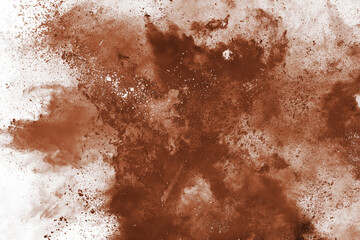 Brown color powder explosion on white background. Colored cloud. Colorful dust explode. Paint Holi.
