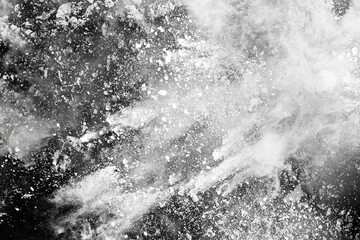 White powder explosion on black background. Colored cloud. Colorful dust explode. Paint Holi.