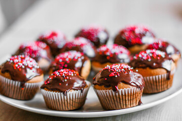 homemade cupcakes and muffins with chocolate toppings and decorations