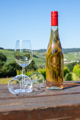 Wine bottle with glasses on wooden table