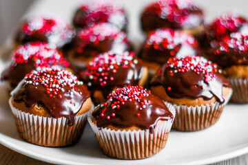 homemade cupcakes and muffins with chocolate toppings and decorations