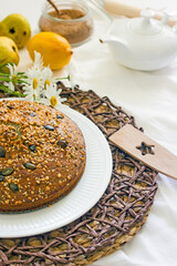 Homemade poppy seed pie with nuts on a light table, close-up