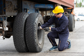 Technical engineer checking tire of a truck. - 365715731
