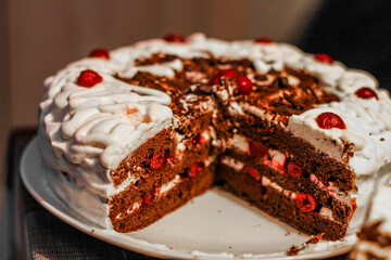 cake with red cherries and white cream topping
