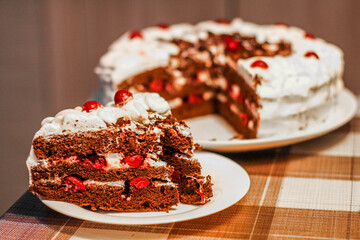 cake with red cherries and white cream topping