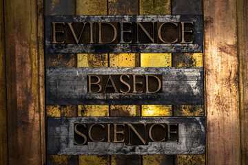 Evidence Based Science text formed with real authentic typeset letters on vintage textured silver grunge copper and gold background