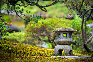 Kyoto, Japan green spring moss garden in Imperial Palace with small stone lantern and bonsai trees...