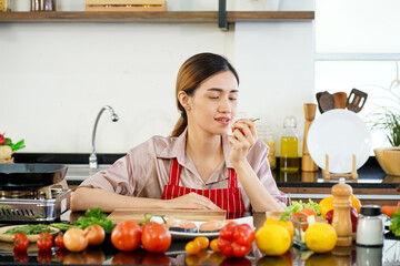 young attractive Asian woman recording cooking lesson online live streaming vlogger in the kitchen. Work from home concept. social media influencer concept.