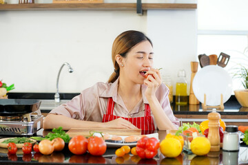 young attractive Asian woman recording cooking lesson online live streaming vlogger in the kitchen. Work from home concept. social media influencer concept.