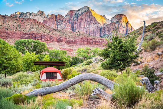 Zion National Park In Utah With Tent Camp Site At Watchman Campground By Rocks, Plants Trees And View Of Cliffs At Sunset