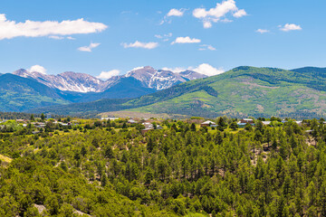 Landscape high angle panoramic cityscape view during summer from High Road to Taos of mountains and village called Truchas in New Mexico, USA