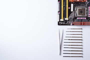on a white background laid out the motherboard and other computer components and tools