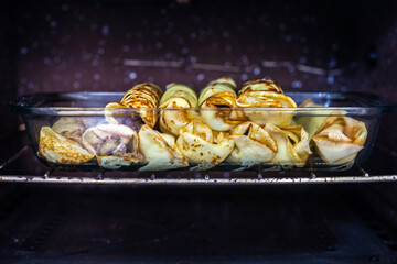 Brazilian pancake rolls stuffed with meat in the oven