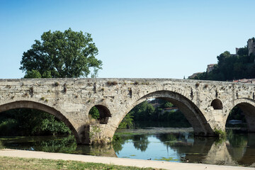 Fototapeta na wymiar retail of old roman bridge and cathedral St Nazaire background in Beziers the city in south France