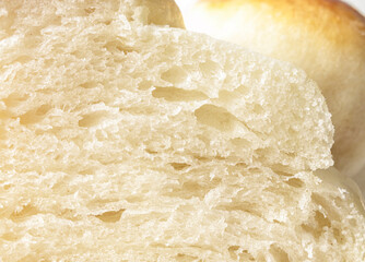 Closeup of sliced yeast bread. Detail shot of a soft fluffy Challah bread, traditional Swiss Butter Zopf or a classic white bread loaf.