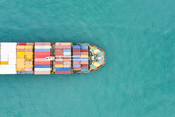 View from above, stunning aerial view of a cargo ship sailing with hundreds of colored containers...
