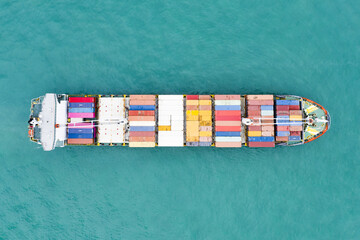 View from above, stunning aerial view of a cargo ship sailing with hundreds of colored containers...
