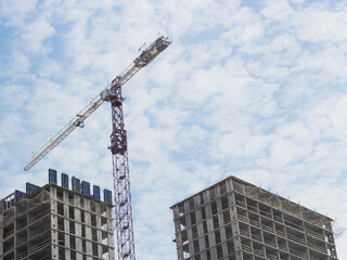 Fototapeta na wymiar Construction site with crane and building on sky background