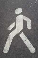 pedestrian crossing sign on asphalt