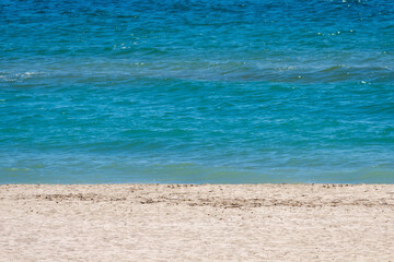 Fototapeta na wymiar beach coastline, yellow sand, azure sea with small waves
