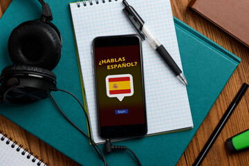 Learning Spanish using a phone app and headphones