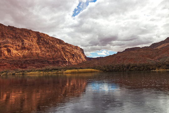Light seeping through thick blanker of clouds at the Colorado river, Lees Ferry landing, Page, AZ, USA