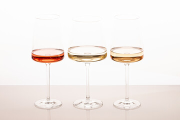 Three glasses of different white and rose wines