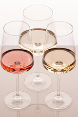 Three glasses of different white and rose wines