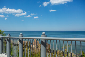 Metal railings on the promenade against the sea