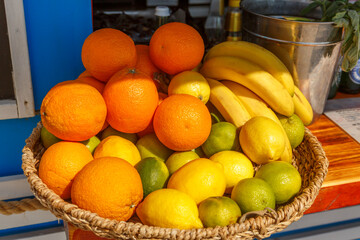 Oranges, lemons, bananas in a wicker basket