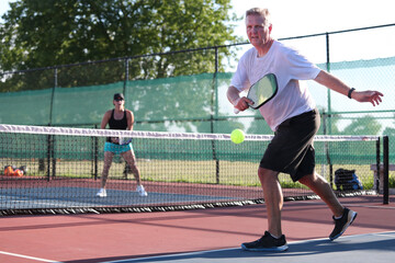 A pickleball is hit out during a mixed doubles match
