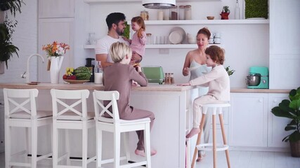happy family with three kids having breakfast in the kitchen in the morning