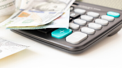 Bookkeeping documents, calculator and money in an office.