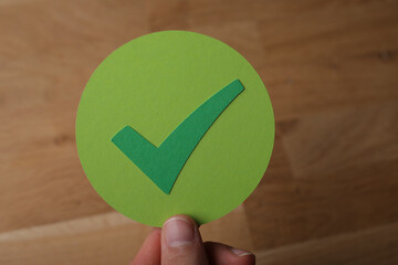check mark in hand paper