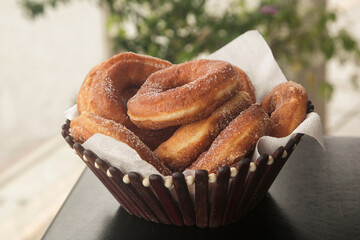 doughnuts in sugar on a plate, close-up