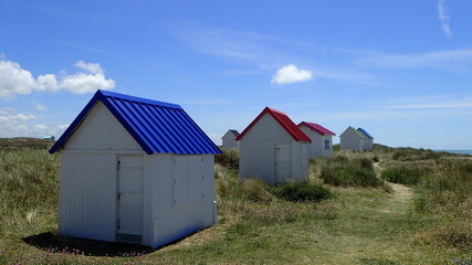 Fototapeta na wymiar beach hut with colorful roofs on the French coast