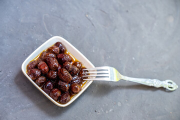 Small plate of olives with oil