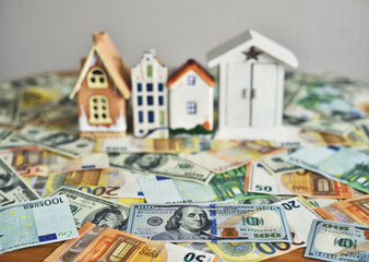 money and house model on the table. concept on the topic of construction and money