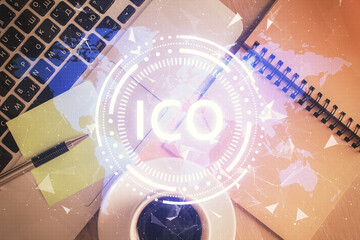 Blockchain theme hologram drawings over computer on the desktop background. Top view. Double...