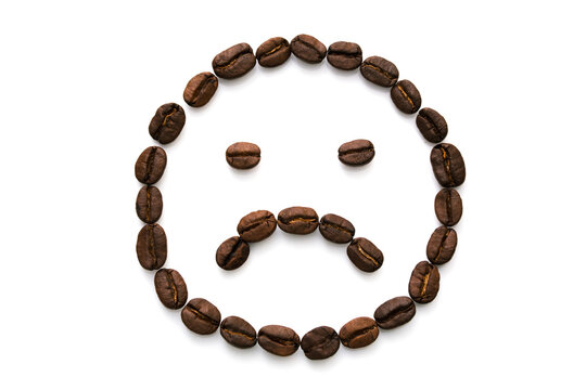 Image of a sad smiley face made of many coffee beans