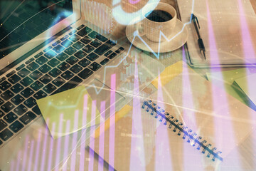 Multi exposure of forex graph drawing and desktop with coffee and items on table background. Concept of financial market trading