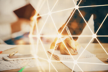 Double exposure of social network theme drawing over people taking notes background. Concept of...