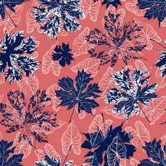 Seamless pattern with silhouettes falling caladium leaves and papaya leaves on a coral pink background. Endless decorative botanical exotic wallpaper