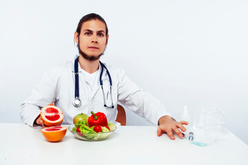 young pretty doctor with stethoscope holding fruits, healthy food care concept