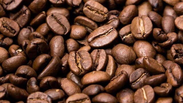 Rotating fresh roasted coffee beans, seamless loop