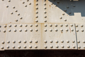 Metal steel post structure with rivets and nuts. Detail of a iron bridge