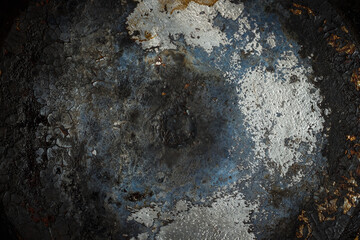 The texture of the burnt bottom of the cast iron pan