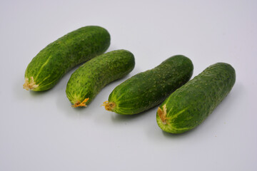 Young juicy cucumbers, Ukrainian cucumber harvest arranged on a white background. Fresh vegetables, healthy food for every day.