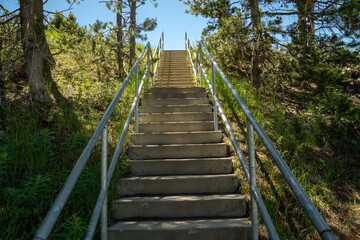 Fototapeta premium Stairs leading down to the beach and fishing area of the Jackson Lake Dam and Reservior in Grand Teton National Park